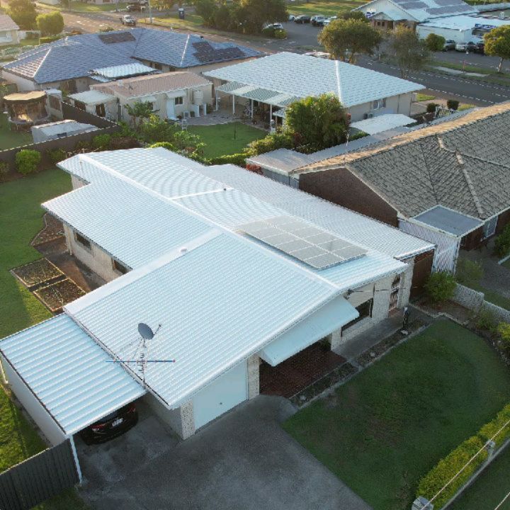 Aerial view of a freshly installed white metal roof in Helensvale